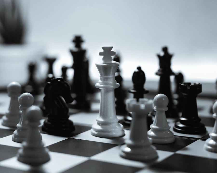 White chess king standing among black and white pieces