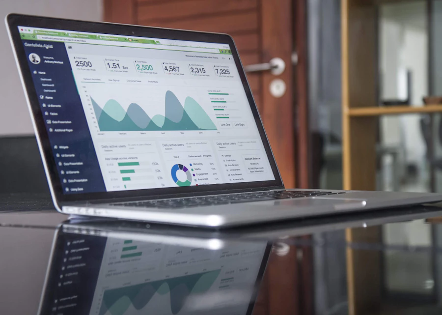 Laptop on a desk showing an analytics dashboard with charts