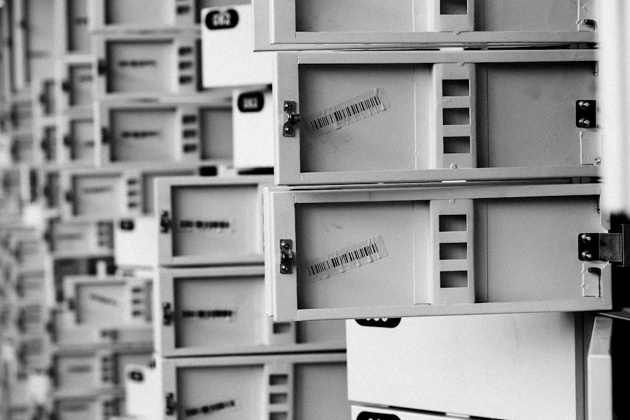Wall of small metal filing drawers in black and white