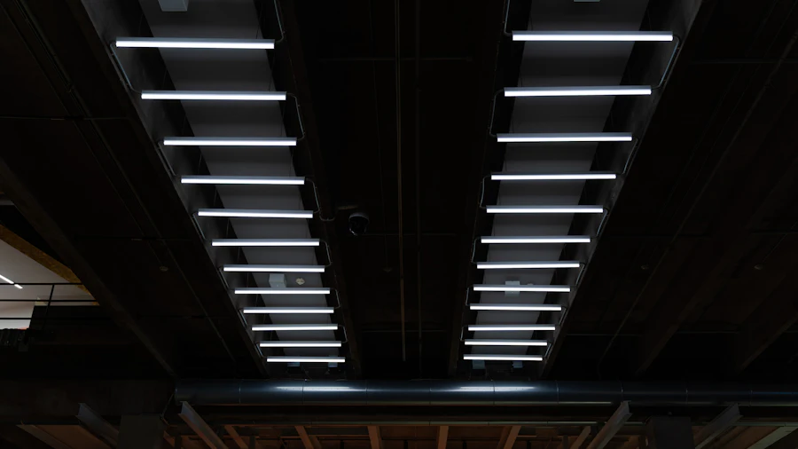 Rows of linear LED light fixtures hanging from a dark ceiling