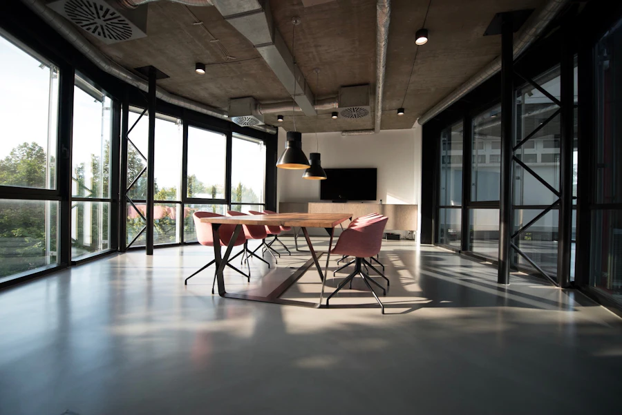 Bright open meeting room with a long table beside floor-to-ceiling windows