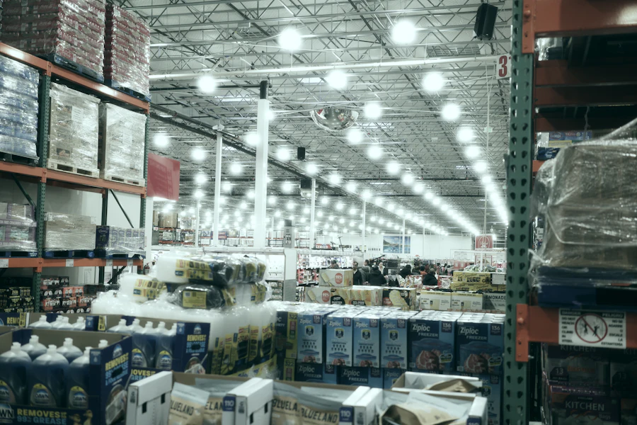 Long warehouse aisle with tall shelving and rows of overhead lights